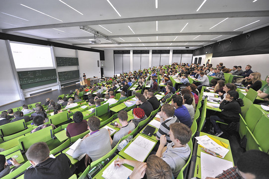 Students on the Master's degree programme in Medical Physics in a lecture theatre with green seating.