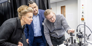 Three people in a lab