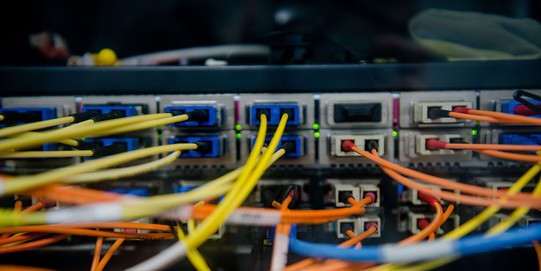 Back of a server with a colorful tangle of cables coming out of it