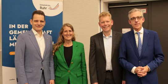 Vier Personen vor einem Roll-up
