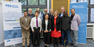 Group photo in front of two Roll-ups
